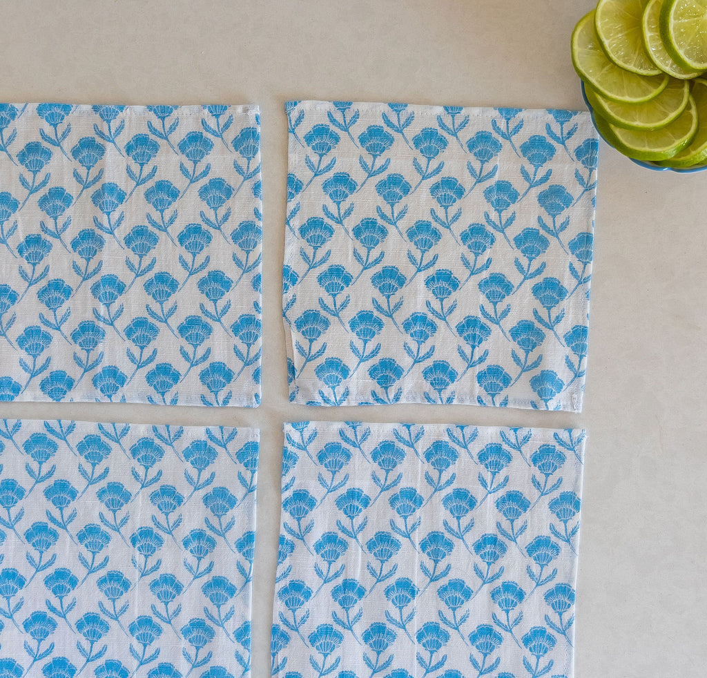 Set of four Del Mar cocktail napkins in a stunning blue floral design. Each napkin is crafted from premium-quality linen, offering a soft and luxurious texture.