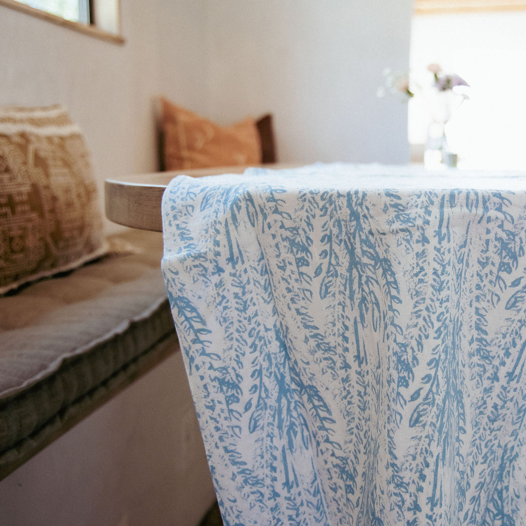 The Laguna Table Runner featuring beautiful patterns of blue and white floral hues. Perfect for any table setting.