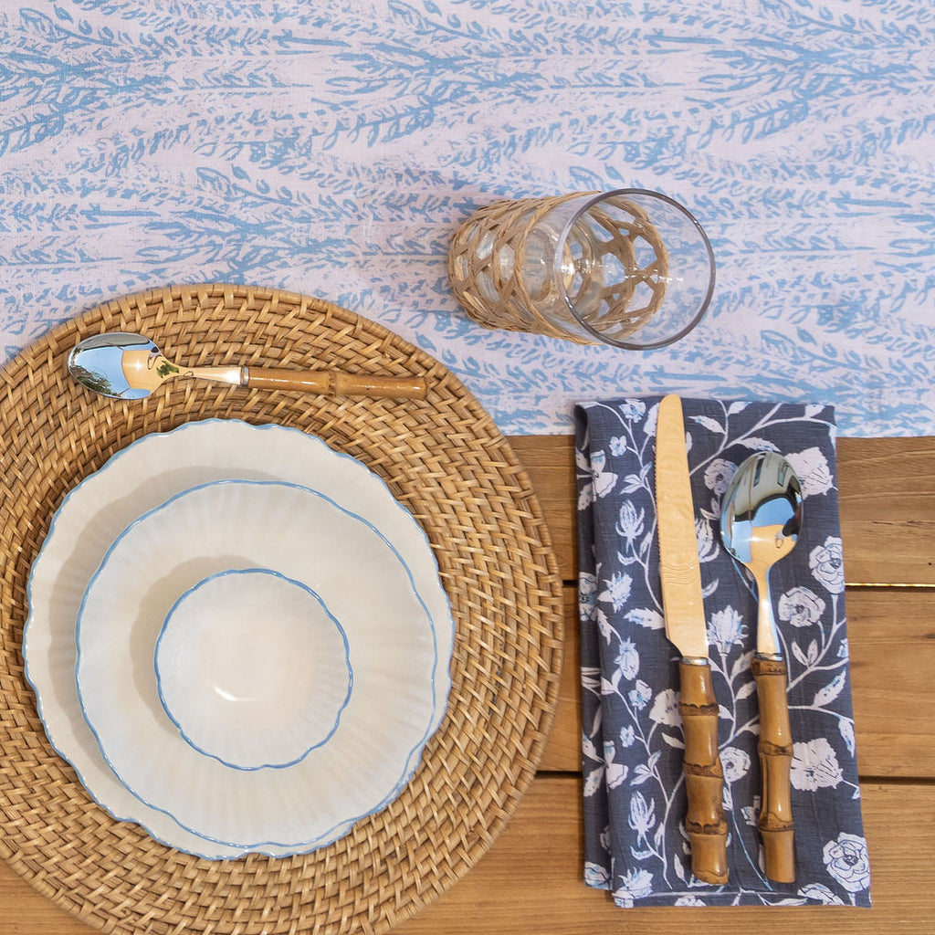 A perfectly set table featuring the Laguna Table runner and dining arrangements. Paired witih a cocktail napkin.