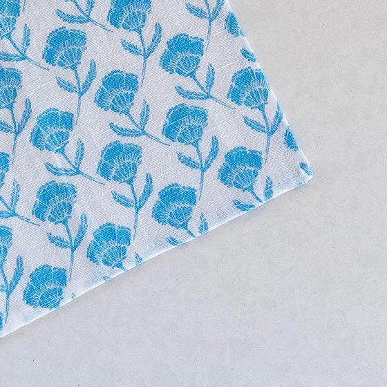 Set of 4 Del Mar cocktail napkins showcasing a captivating blue floral pattern, adding elegance and style to any table setting.