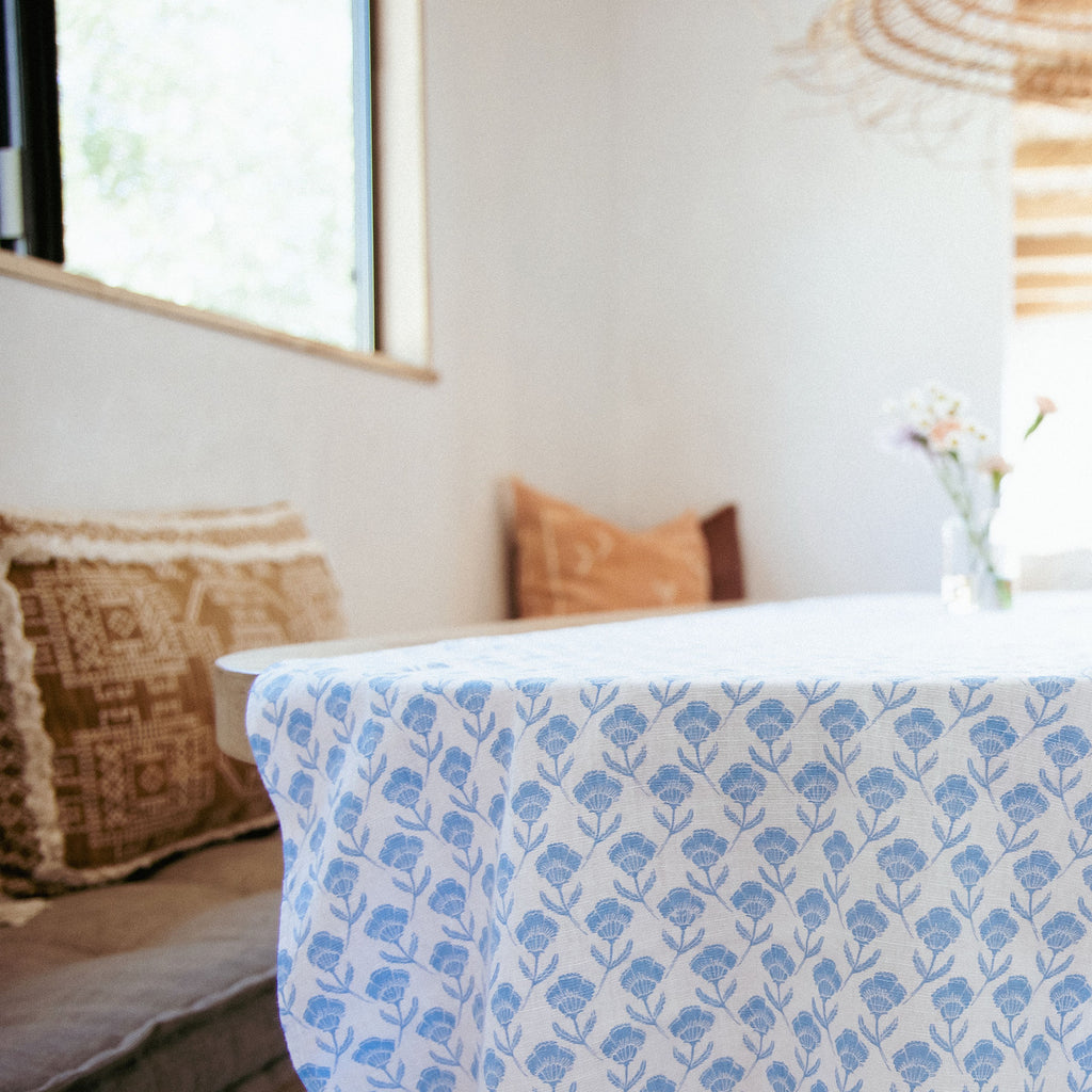 Del Mar table runner in a stunning blue and white floral pattern, adding elegance and charm to any dining space.