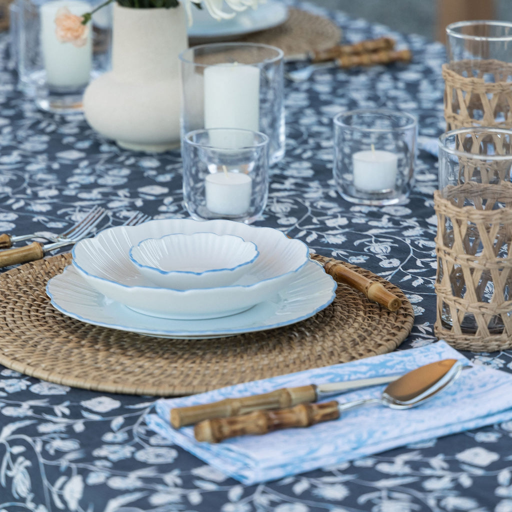 A beautifully-set table, featuring the Montecito Tablecloth. Patterns of blue and white floral hues complement this aesthetic dinner gathering.