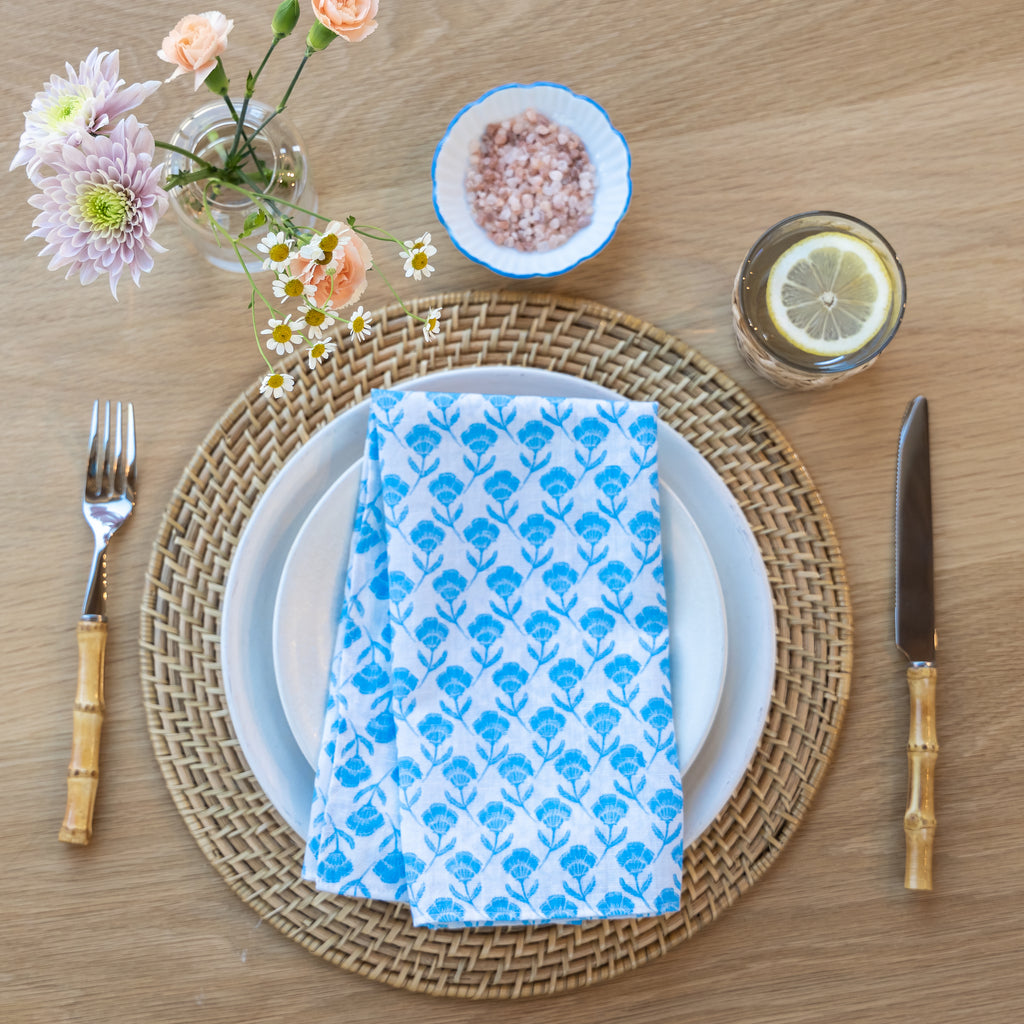 A set of 4 Del Mar cocktail napkins in a captivating blue and white floral pattern. 